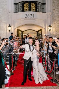 grand wedding exit on red carpet with silver streamers