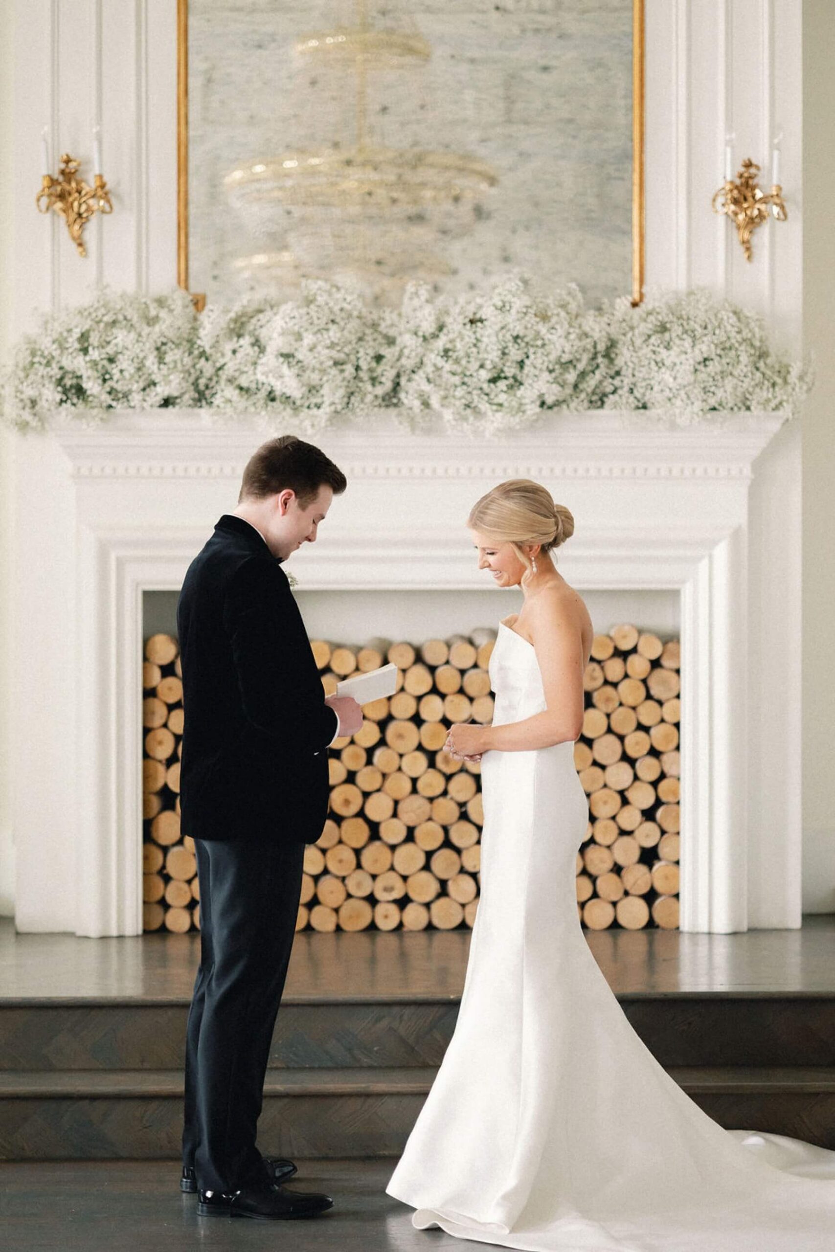 Groom reading vows to bride in front of hearth at The Mason Dallas