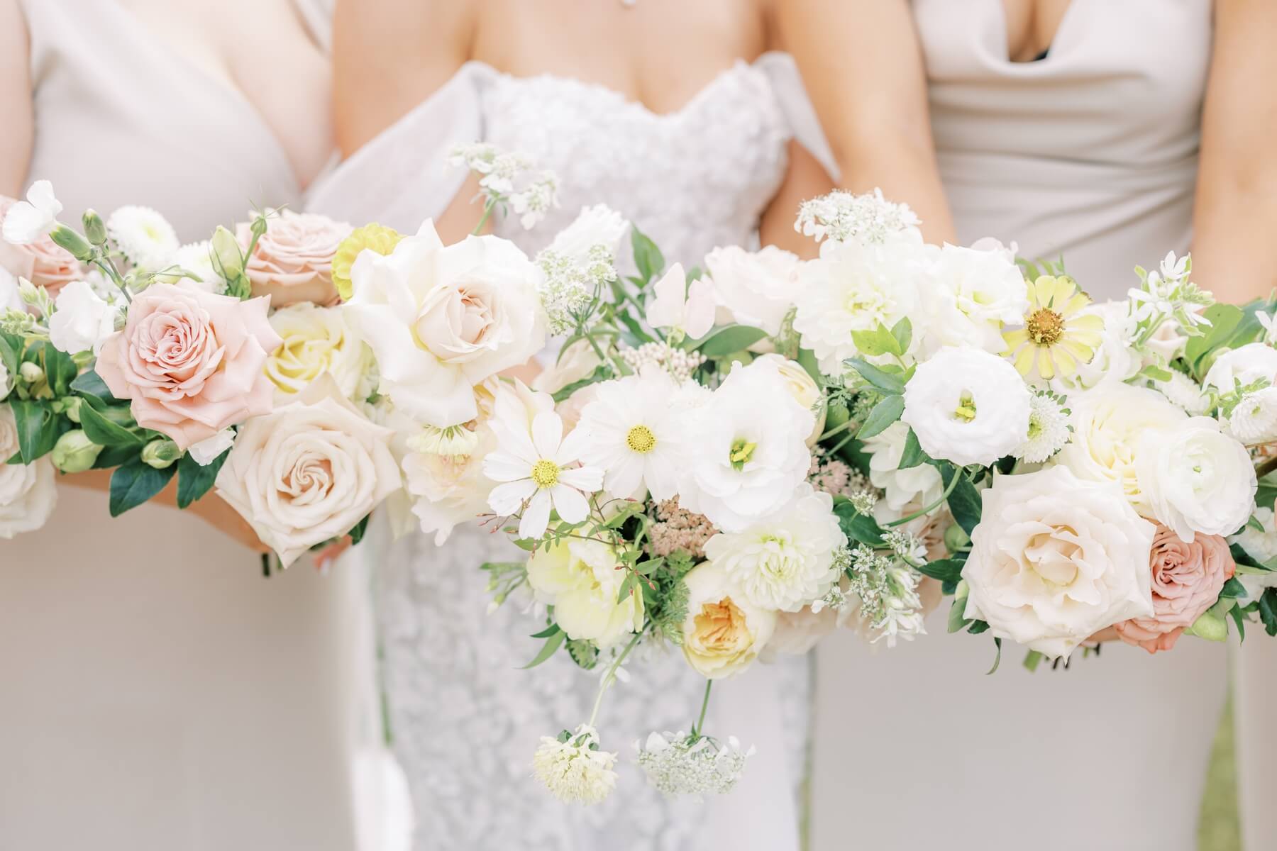Hand tied white and pale pink and yellow wedding bouquets 