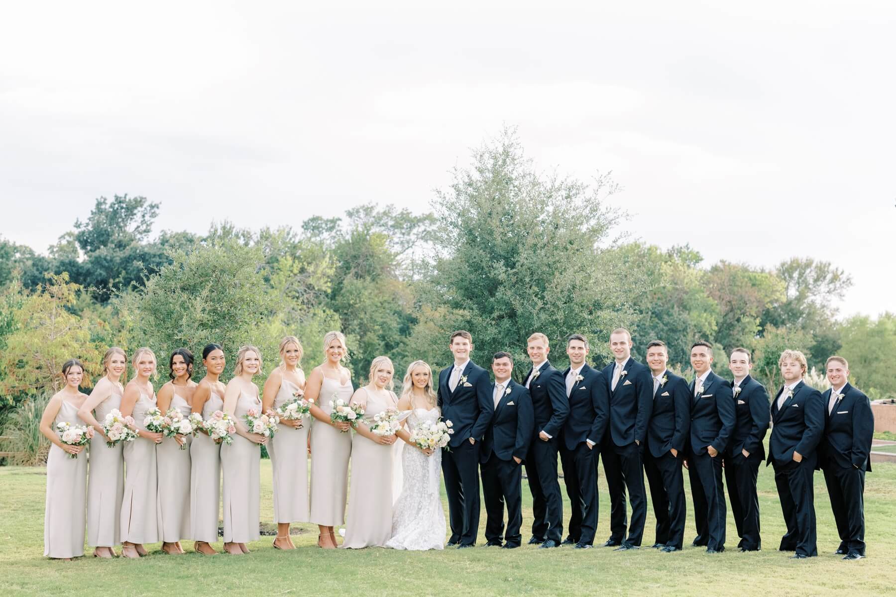 Bride and groom with wedding party at The Springs in McKinney