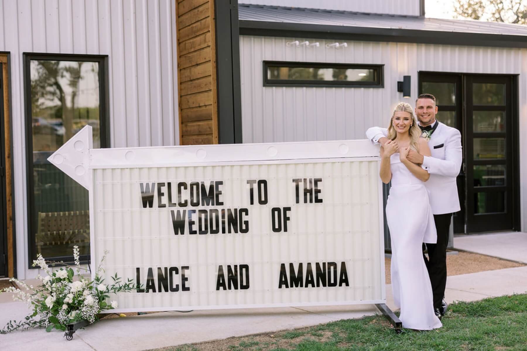 Bride and groom standing next to welcome sign at Union House TX