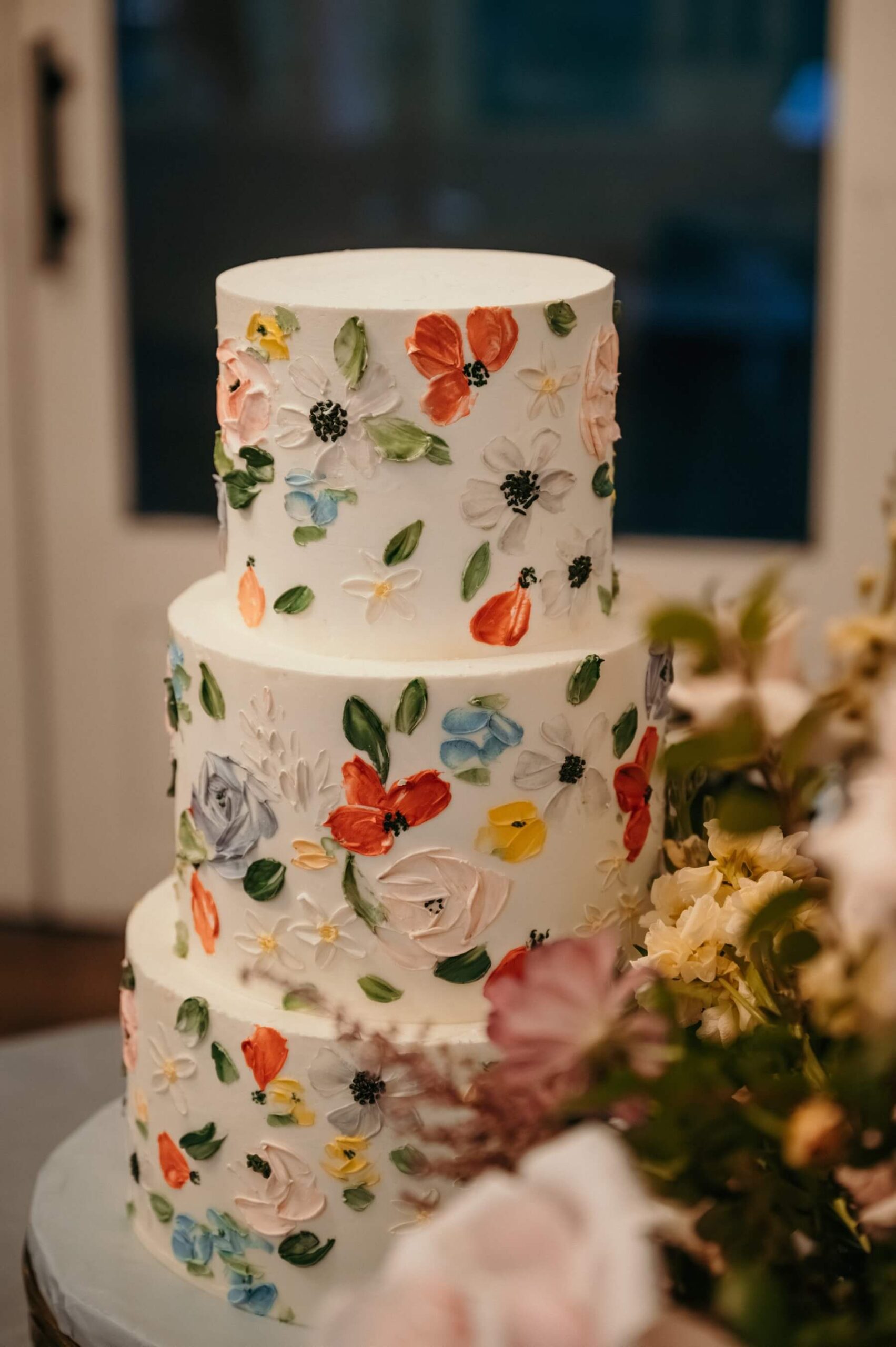 Three tier wedding cake with handprinted flowers