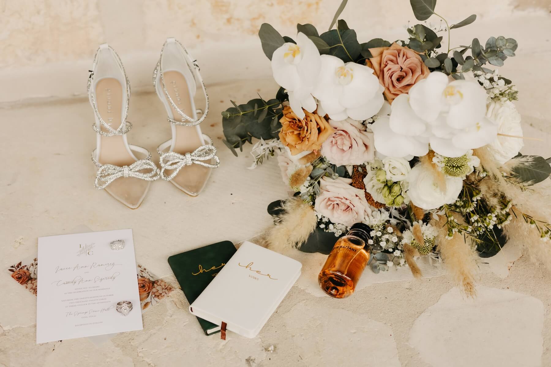 Boho wedding bouquet with crystal bow shoes, wedding invitation, and vow books