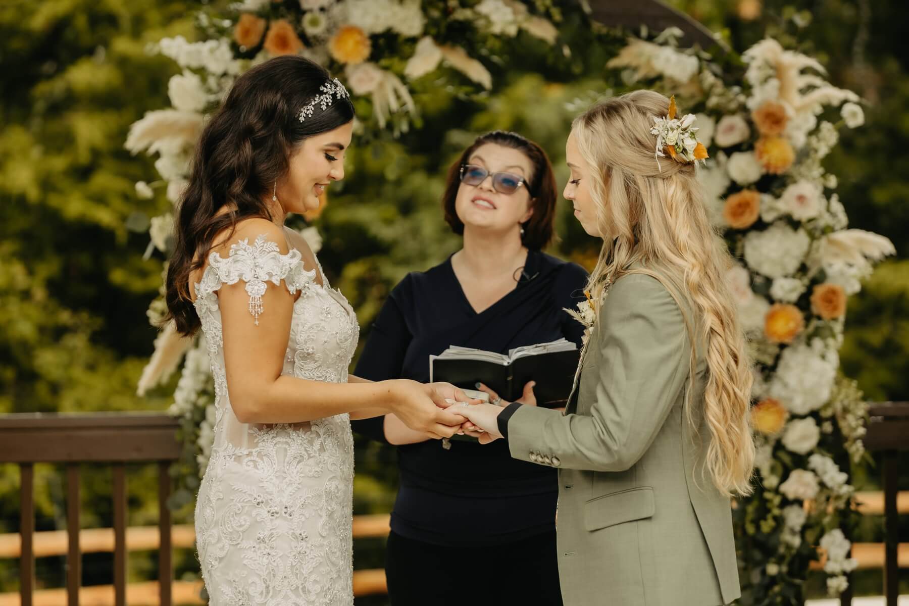 Couple exchanging rings during ceremony at The Springs McKinney Stone Hall