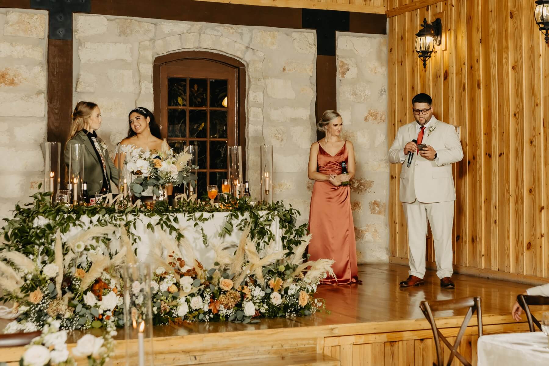 Couple looking at each other during reception speeches at The Springs McKinney Stone Hall