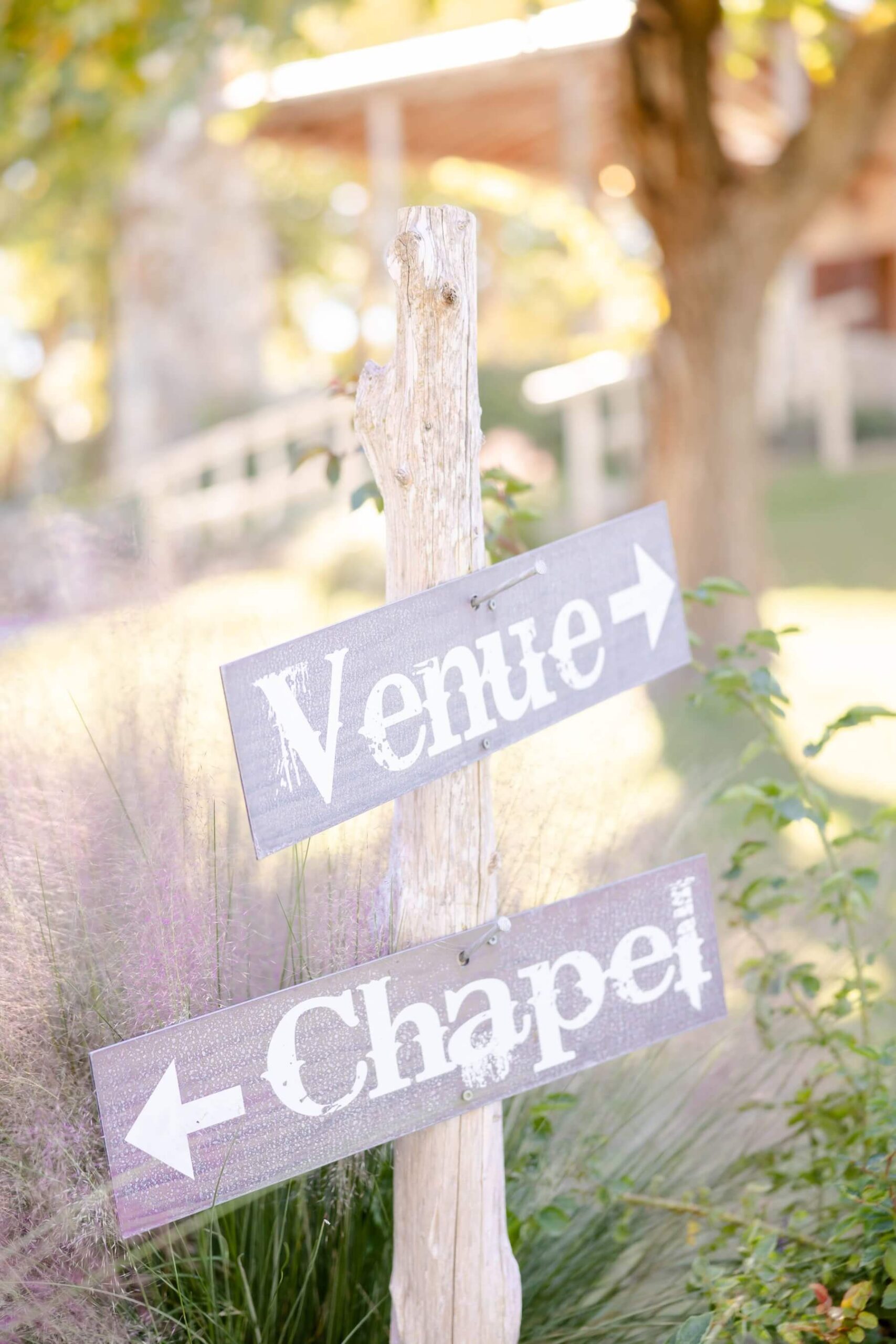 Vintage "venue" and "chapel" sign on wood post