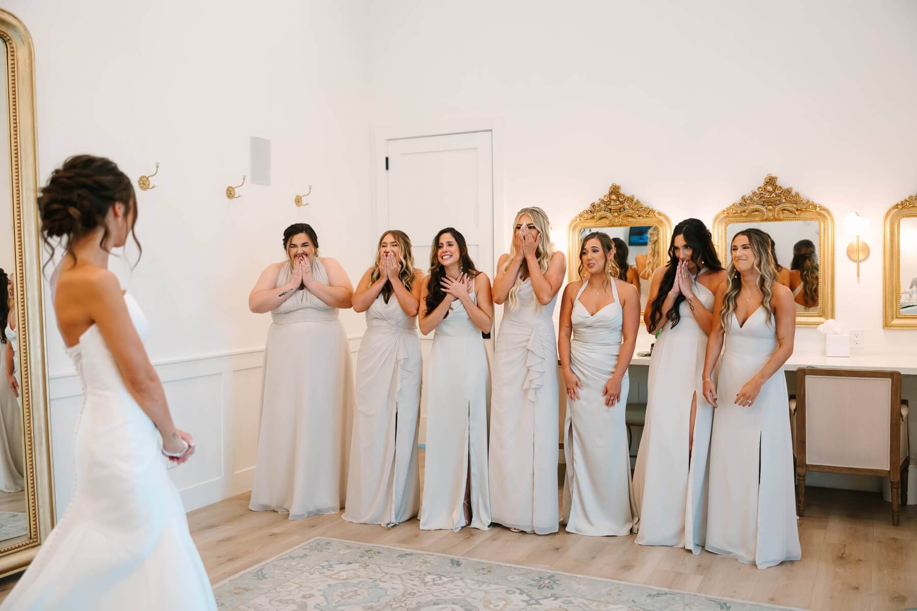 Bridesmaids reacting to seeing bride for the first time