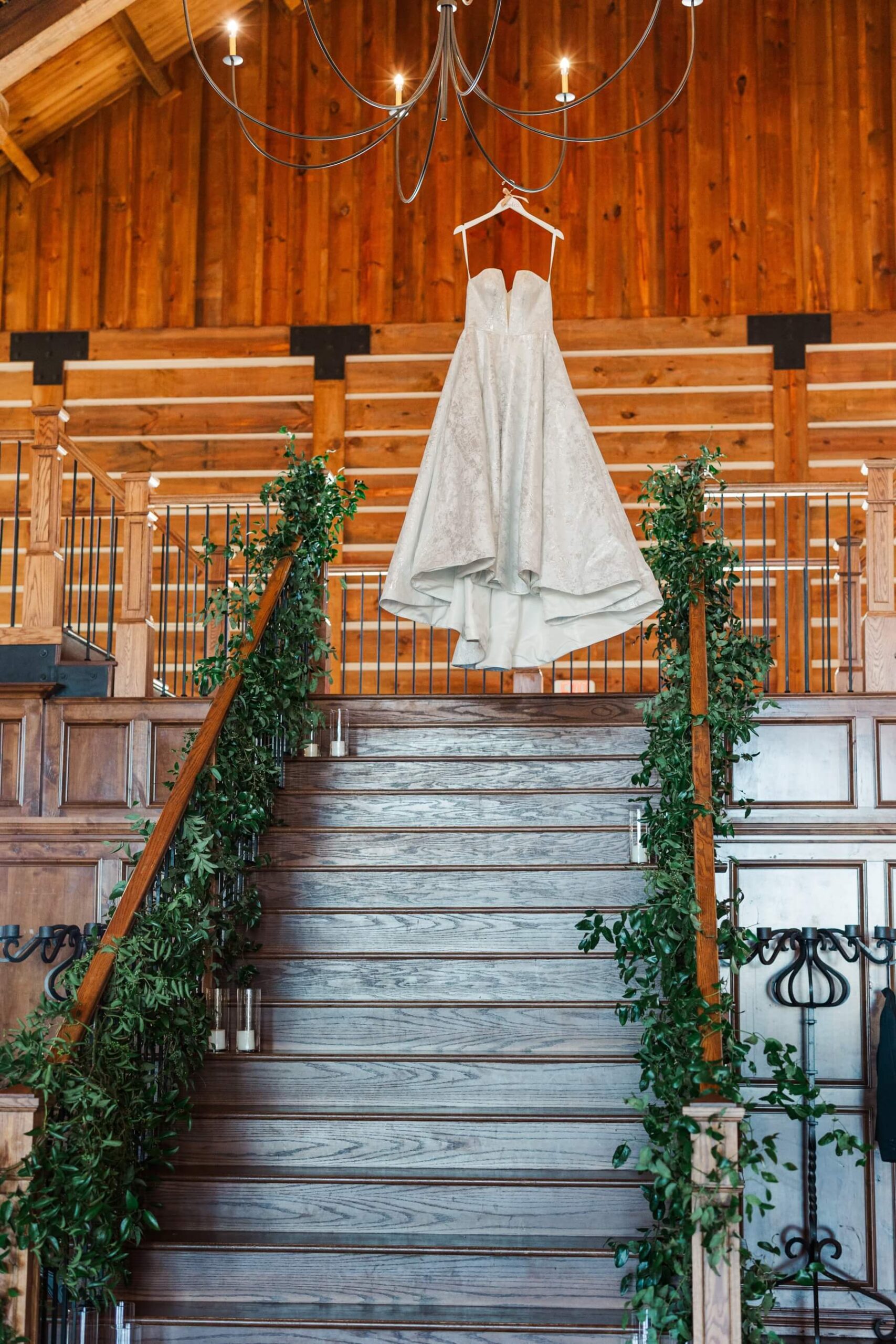 Bride's dress hanging from chandelier at The Lodge at The Springs in Denton