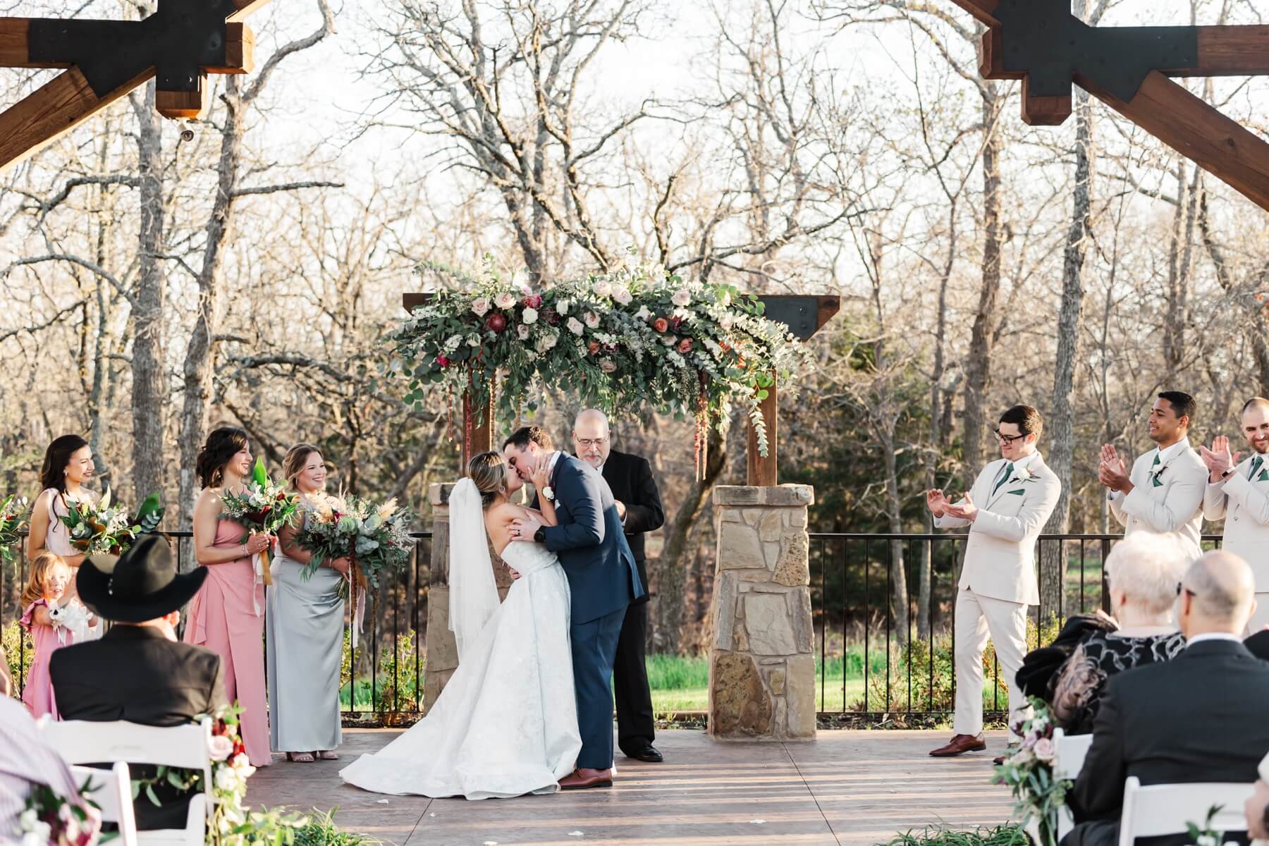 Bride and groom kissing at end of ceremony at The Springs in Denton