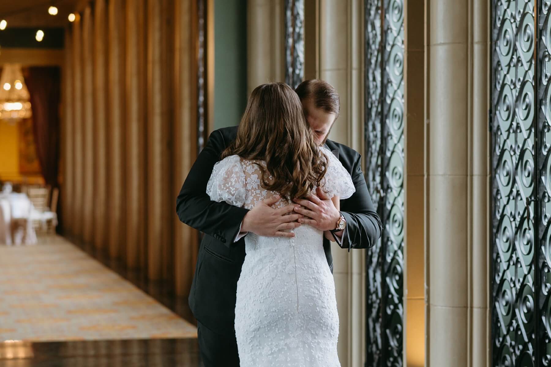 Bride and groom hugging during first look at the Fort Worth Club