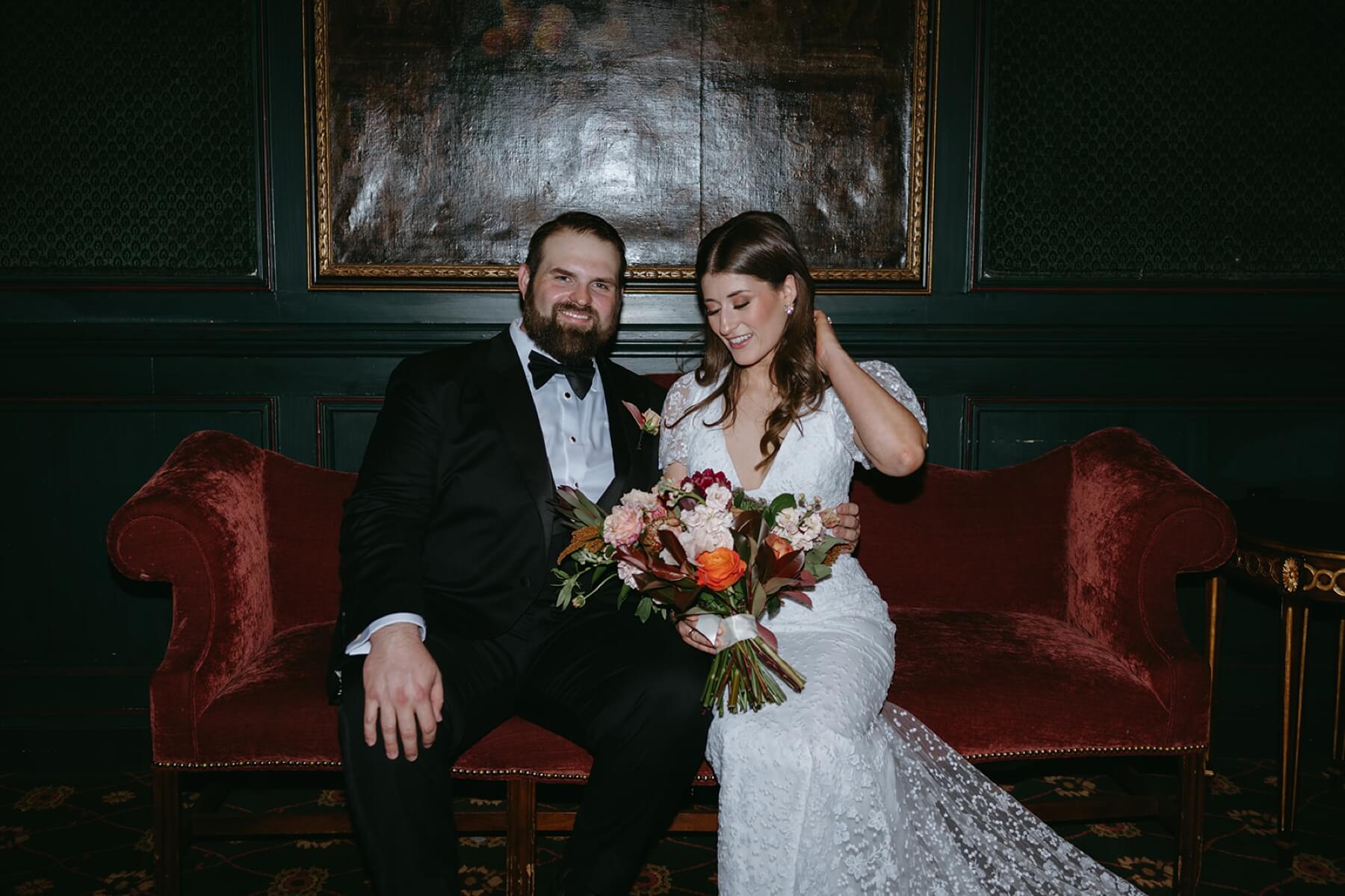 Bride and groom sitting on couch at the Fort Worth Club