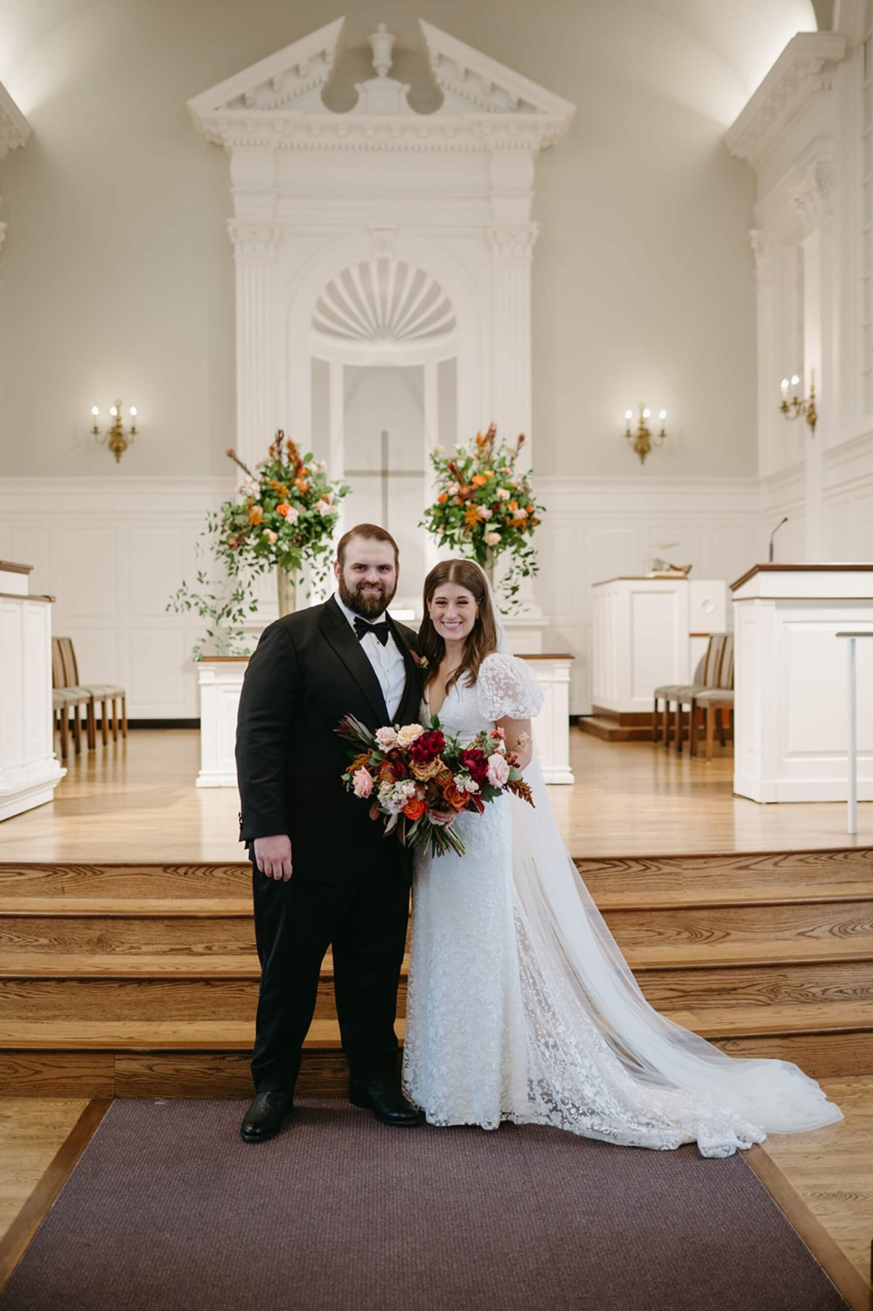 Bride and groom taking photos in Robert Carr Chapel