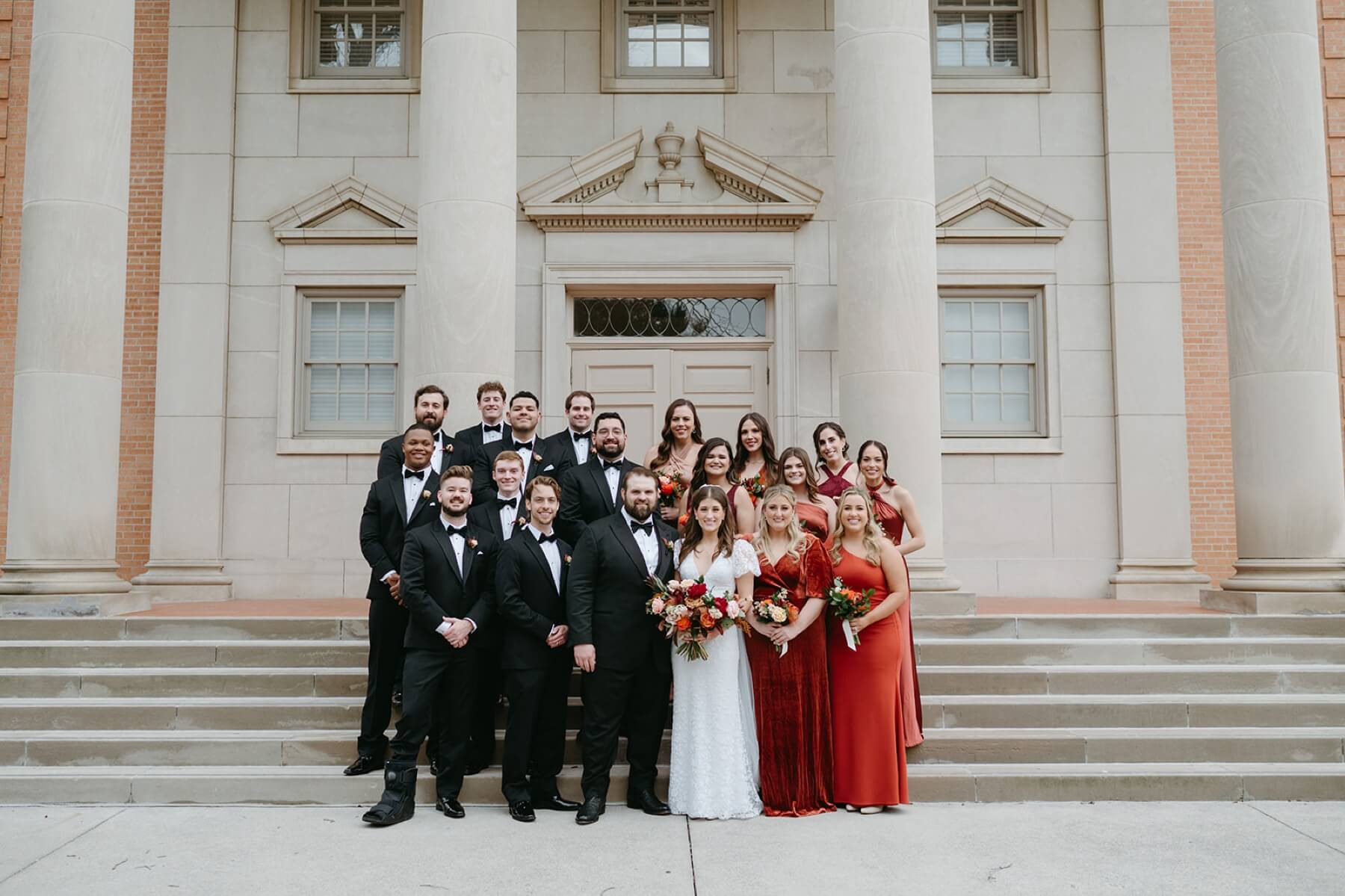 Bride and groom with wedding party on steps of Robert Carr Chapel