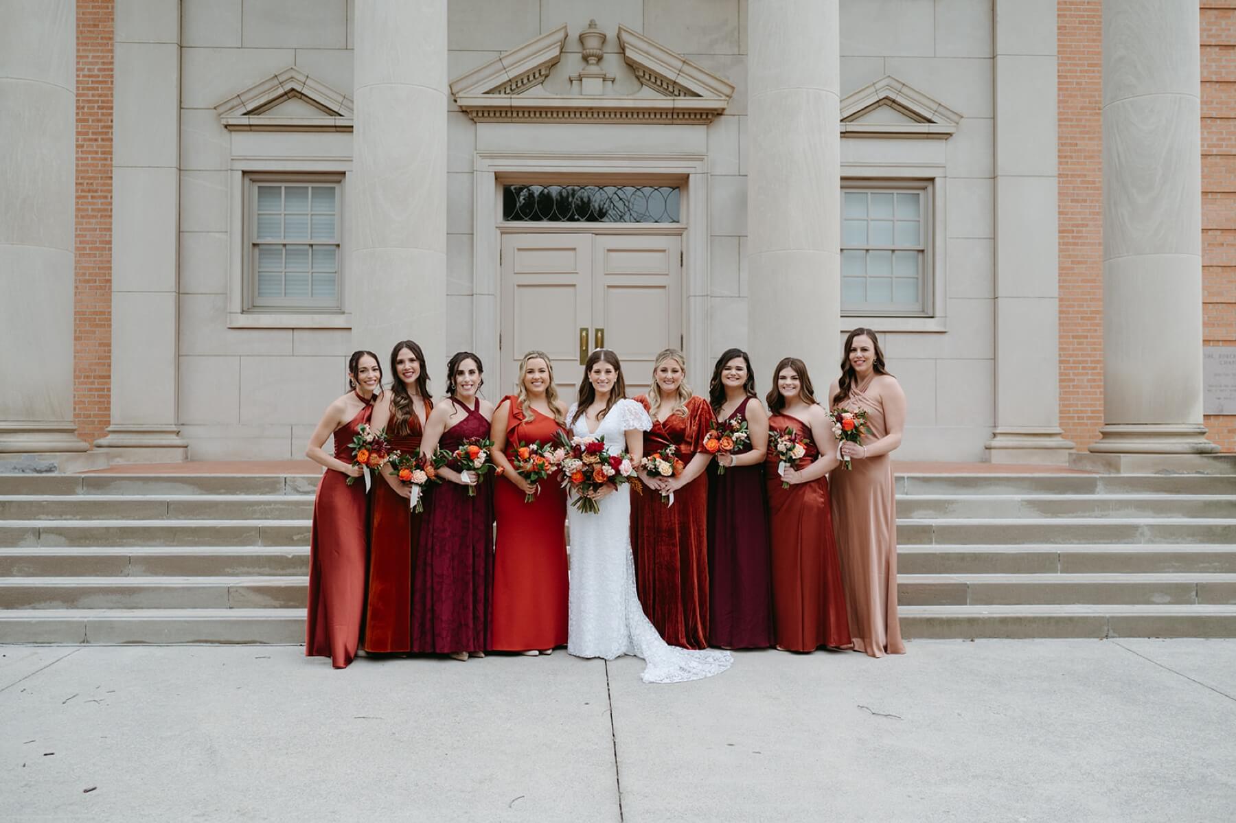 Bride with bridesmaids on steps of Robert Carr Chapel