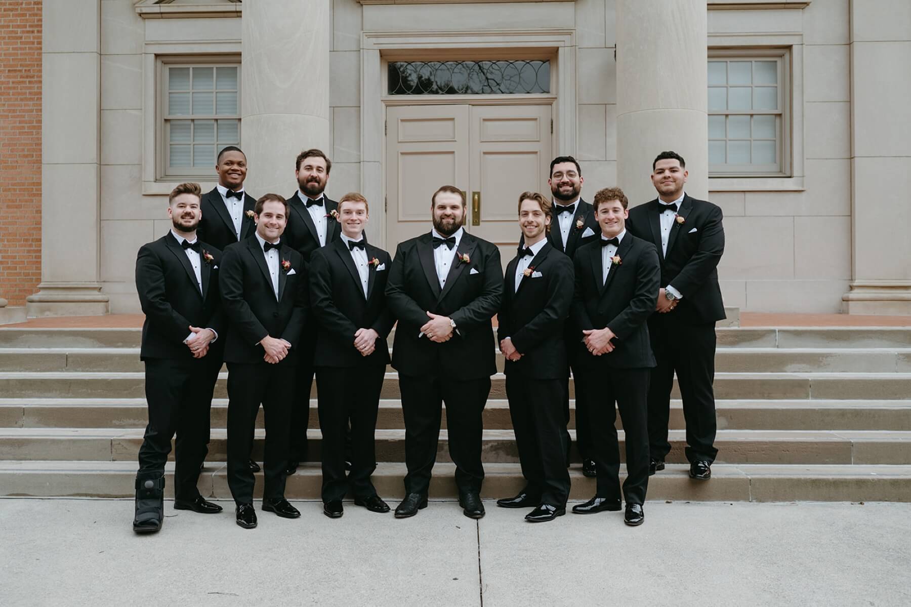 Groom with groomsmen on steps of Robert Carr Chapel