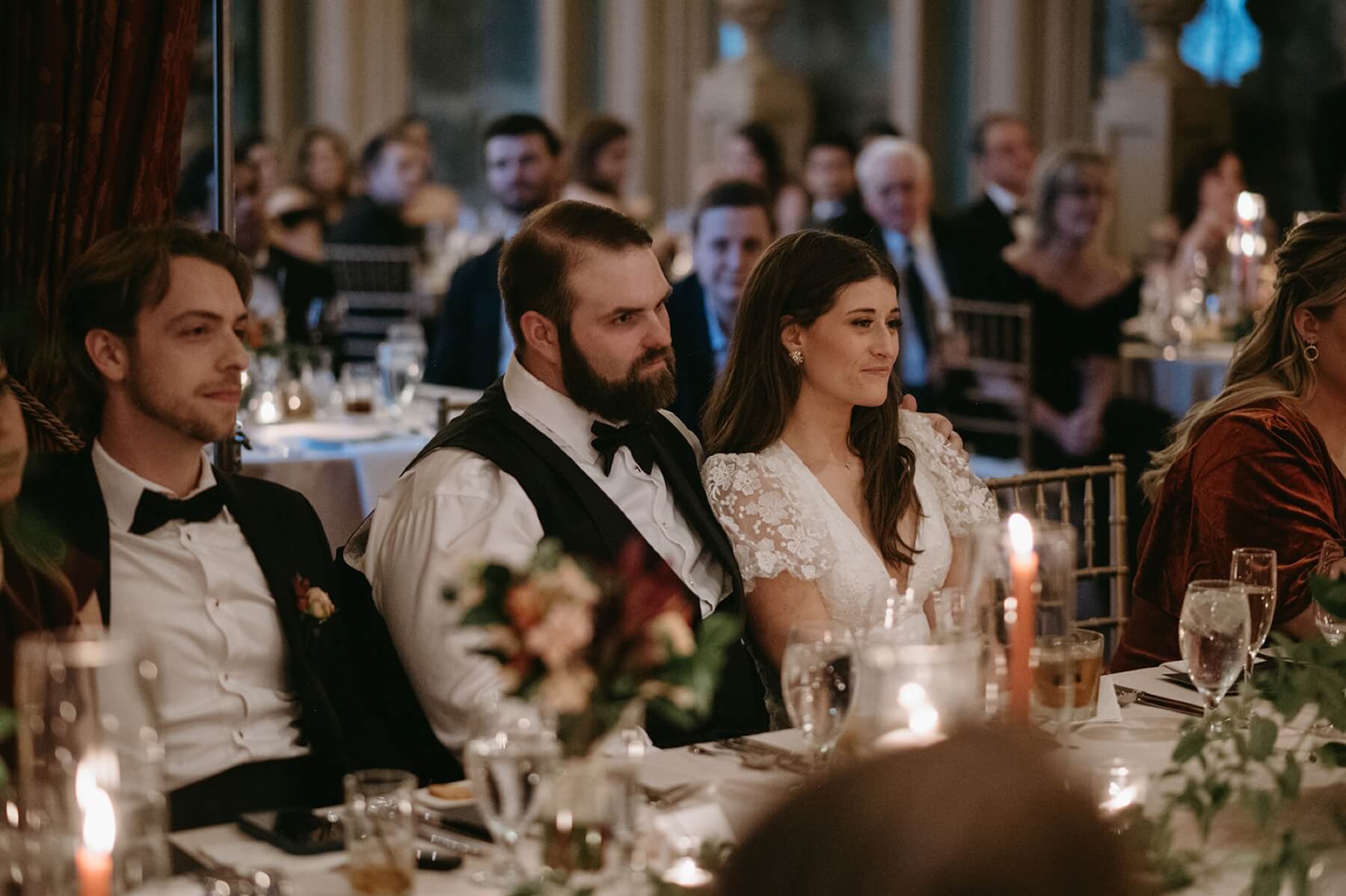 Bride and groom listening to toasts