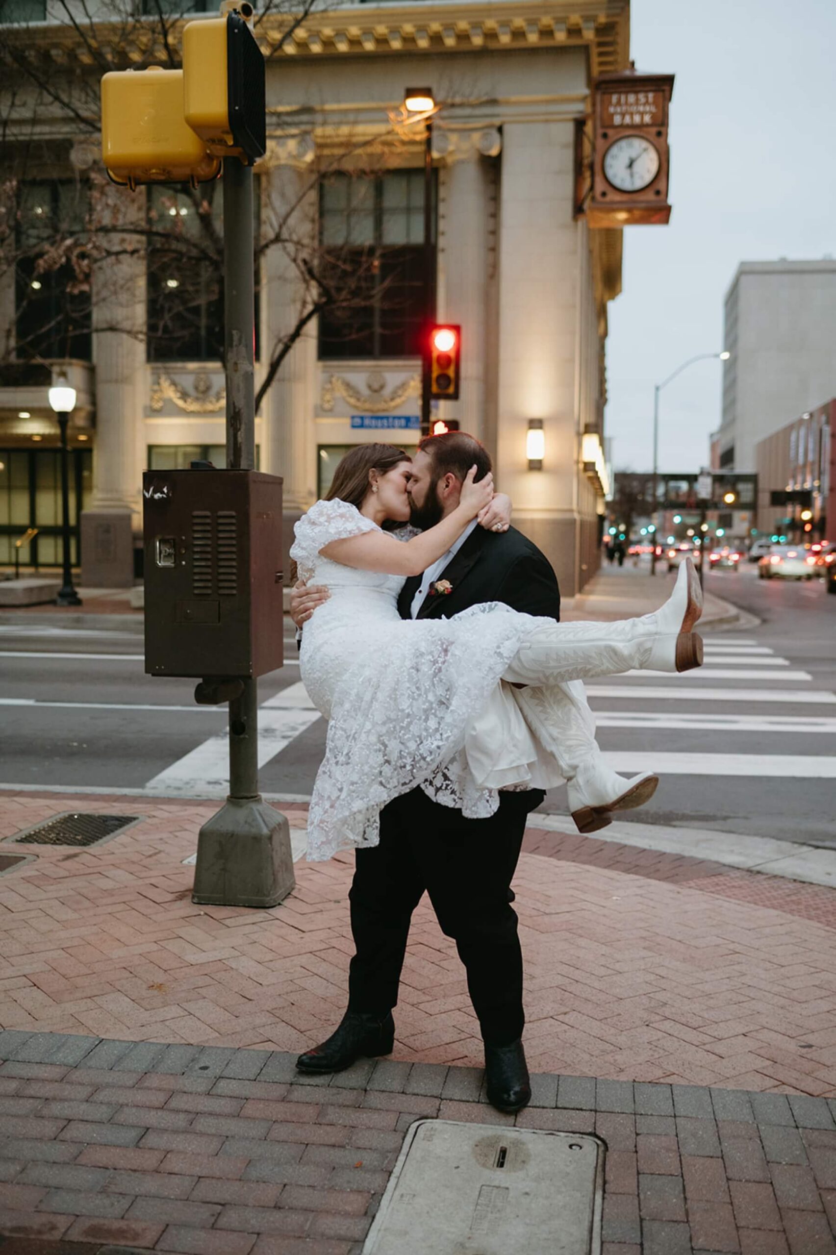 Groom kissing bride in downtown Fort Worth