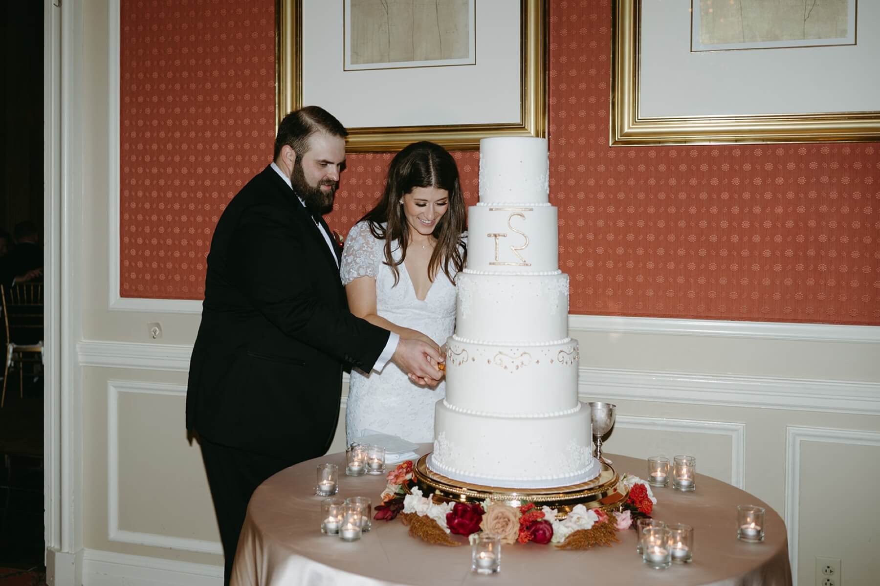 Bride and groom cutting wedding cake