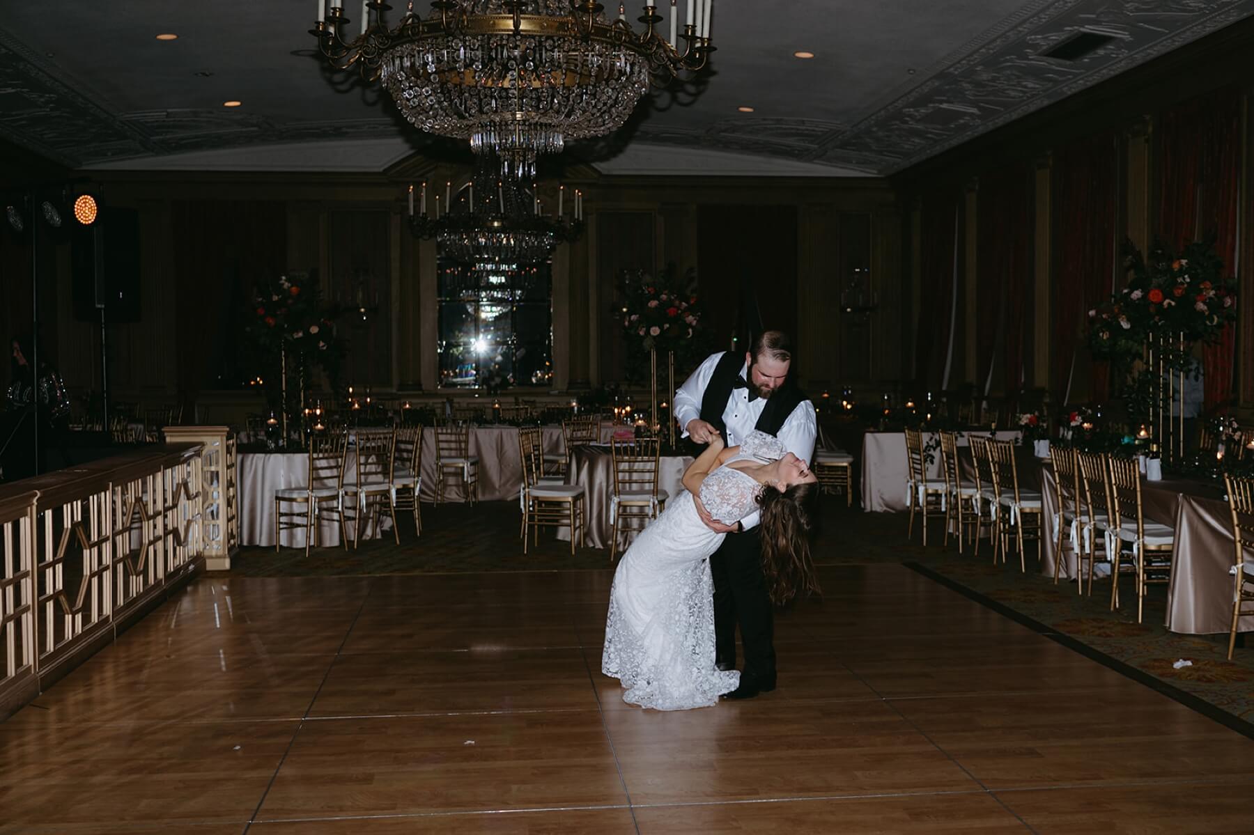 Groom dipping bride during private last dance