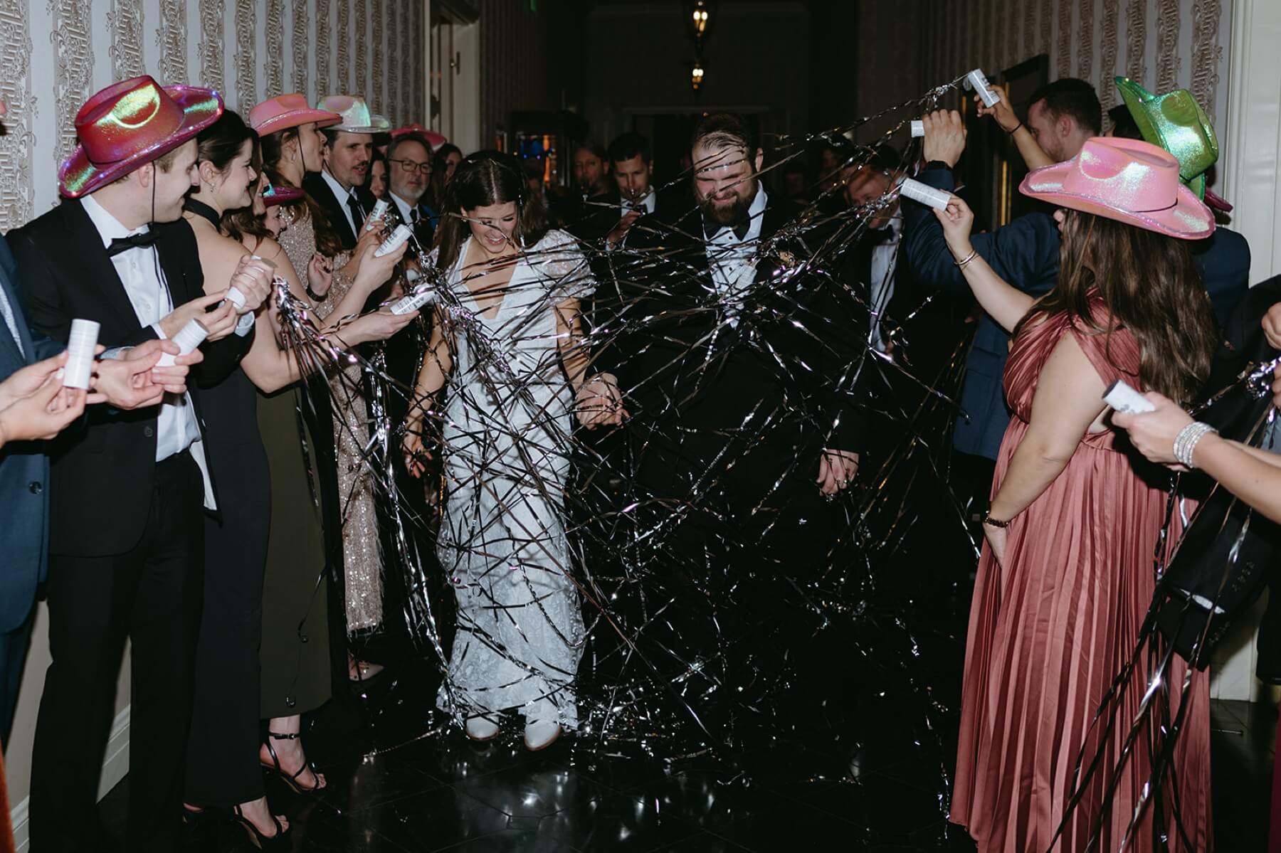 Bride and groom exiting to silver streamers