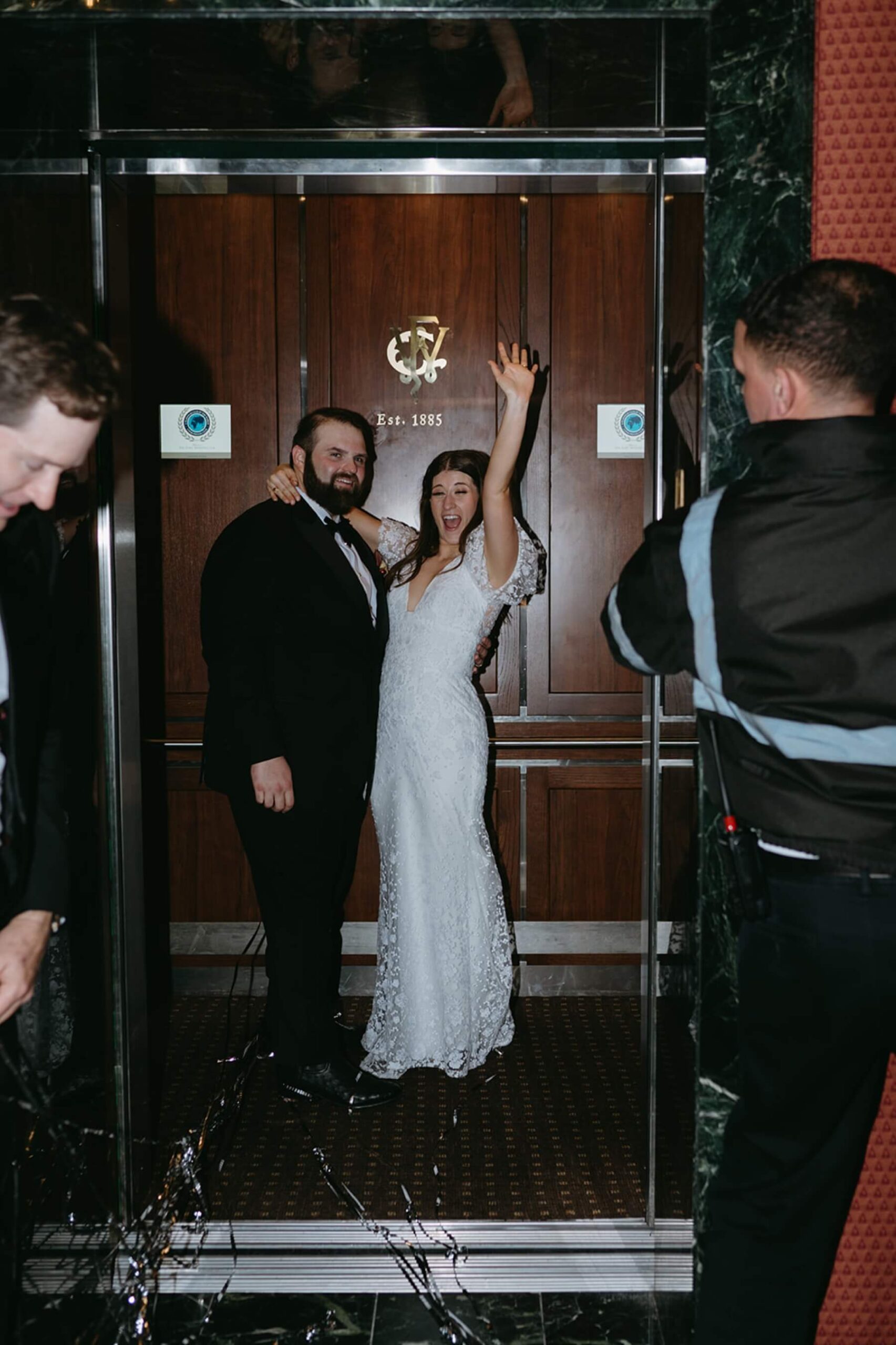 Bride and groom exiting reception in Fort Worth Club elevator