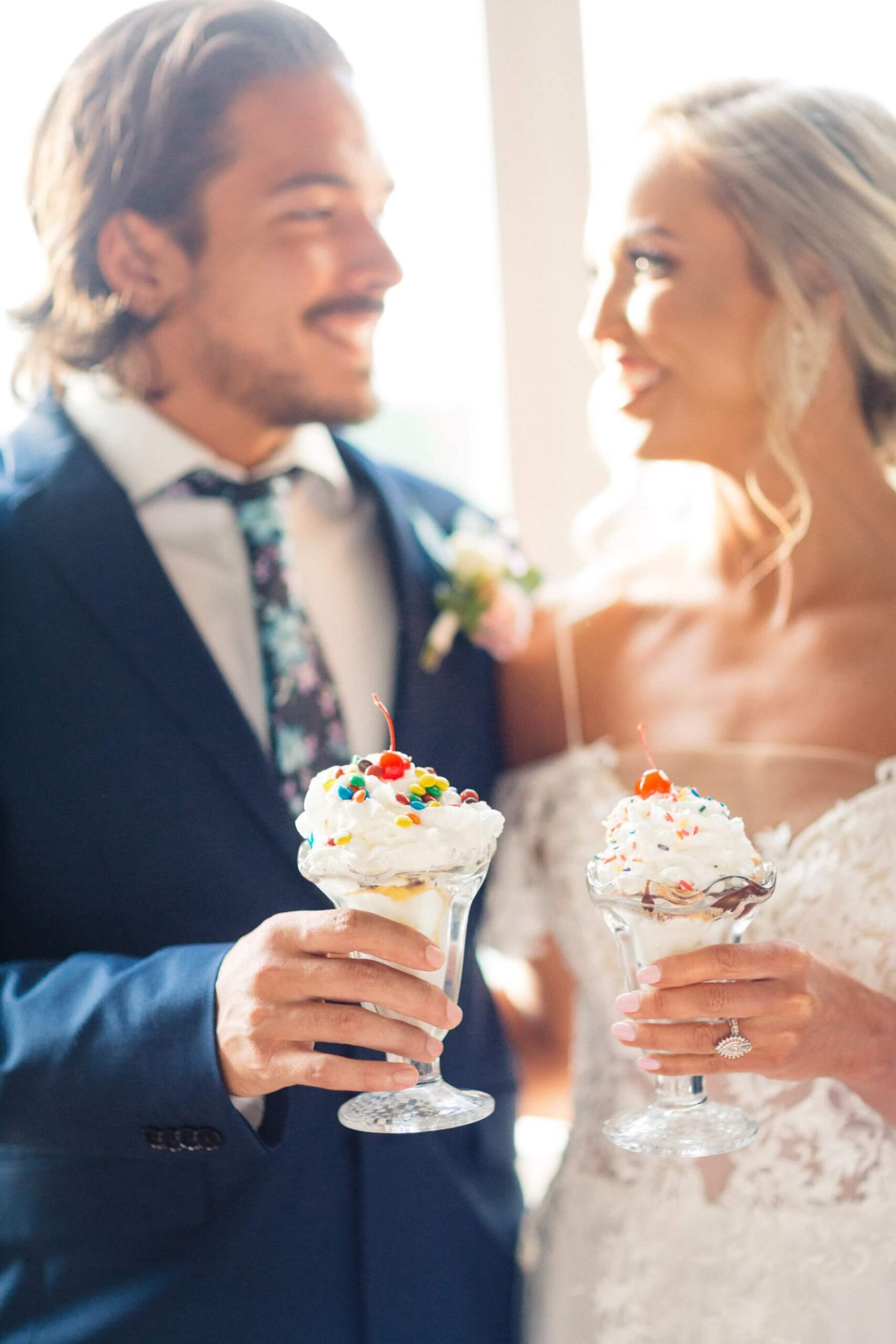 Couple looking at each other while holding ice cream Sundays in post about summer weddings in Dallas