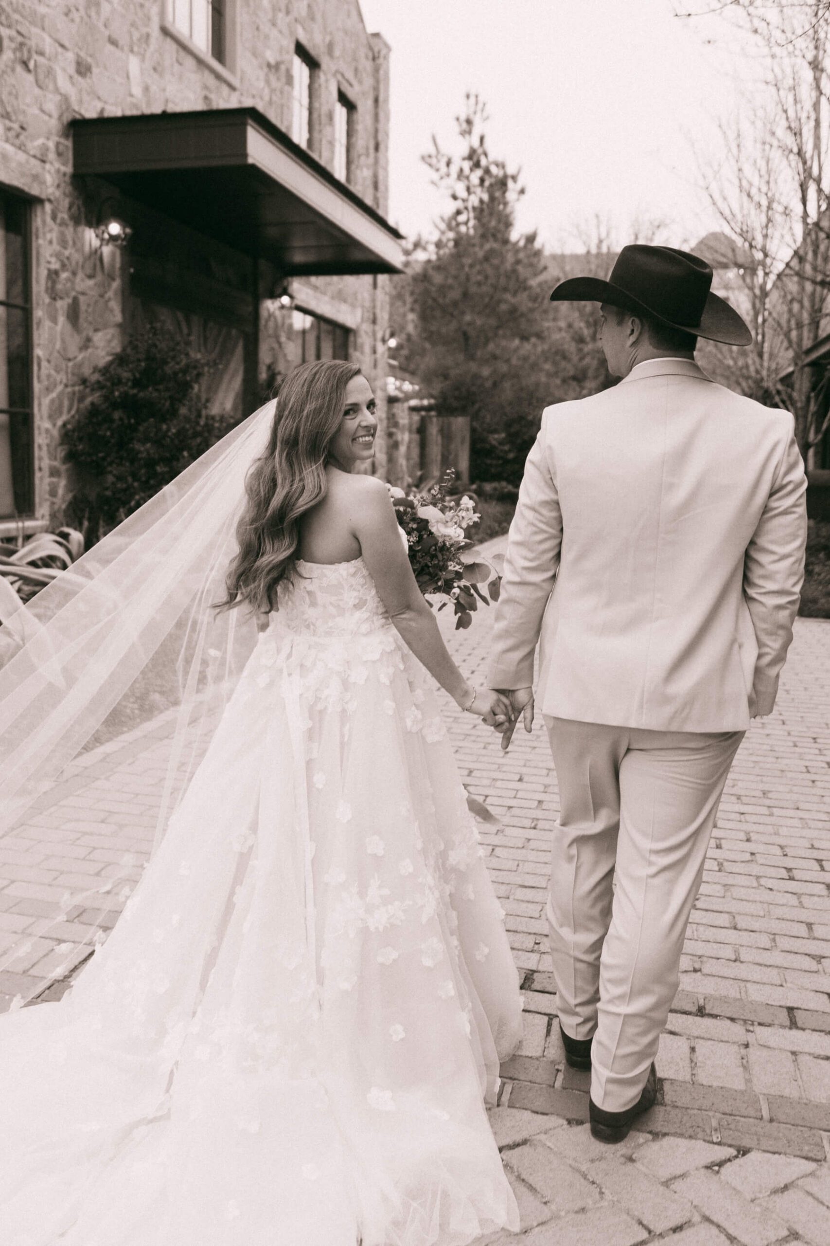 Bride and groom holding hands while walking