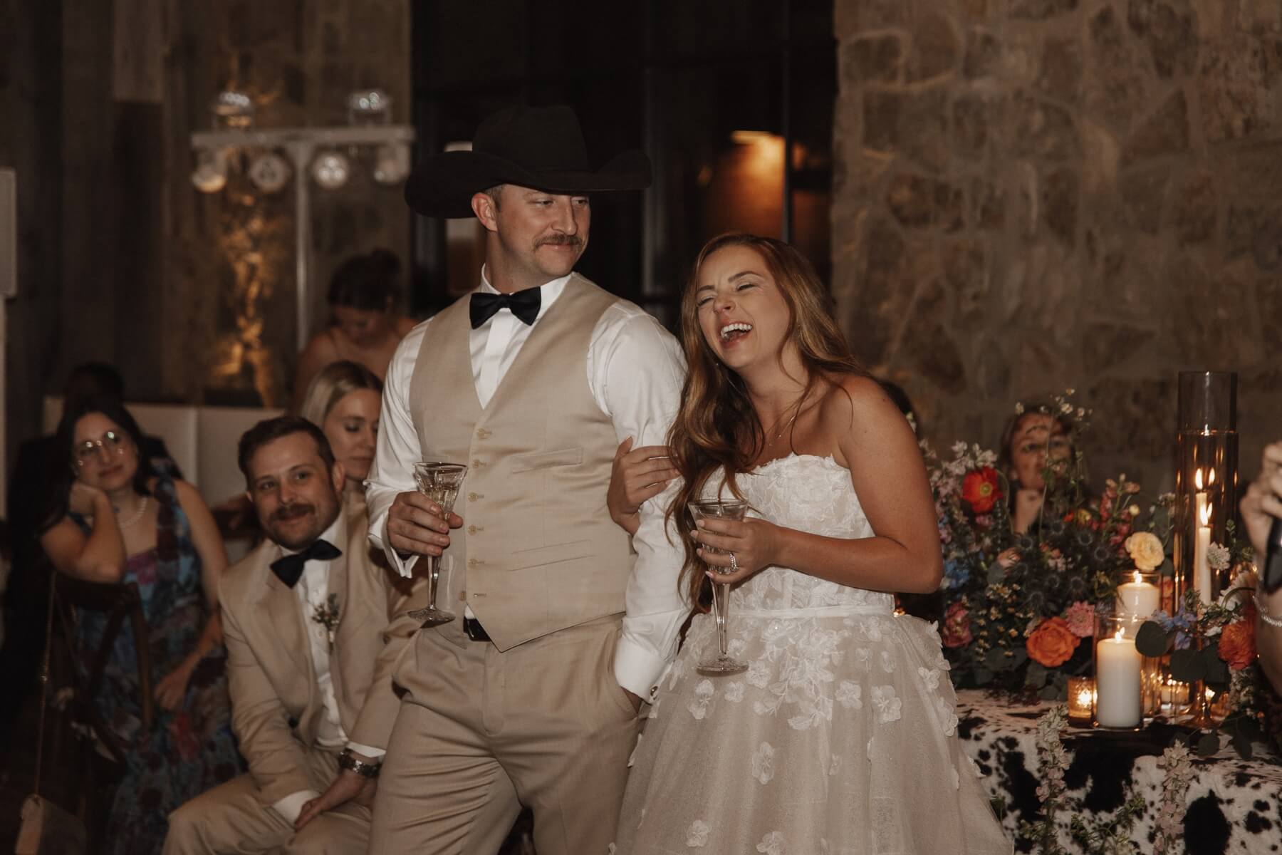 Bride and groom laughing during toasts at Fort Worth wedding