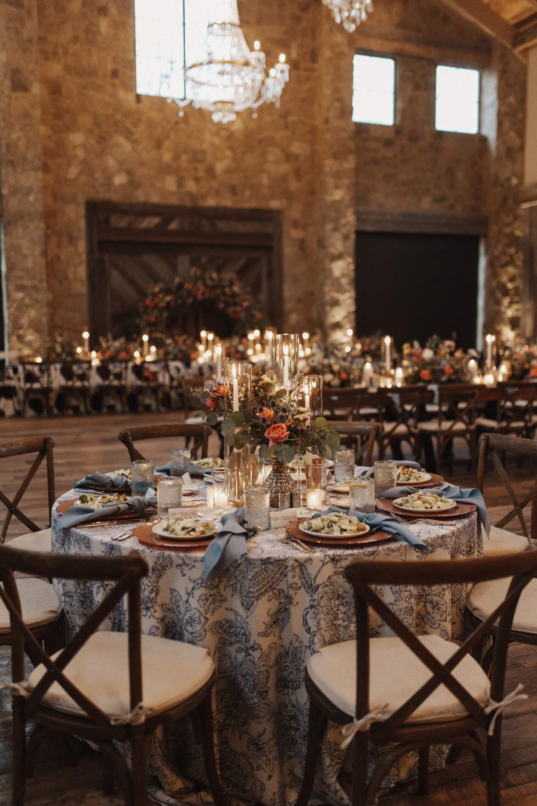 Reception table with pale blue accents and elegant floral arrangement